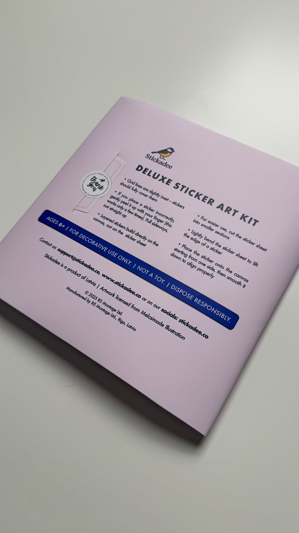 Purple sticker art kit packaging on a white background