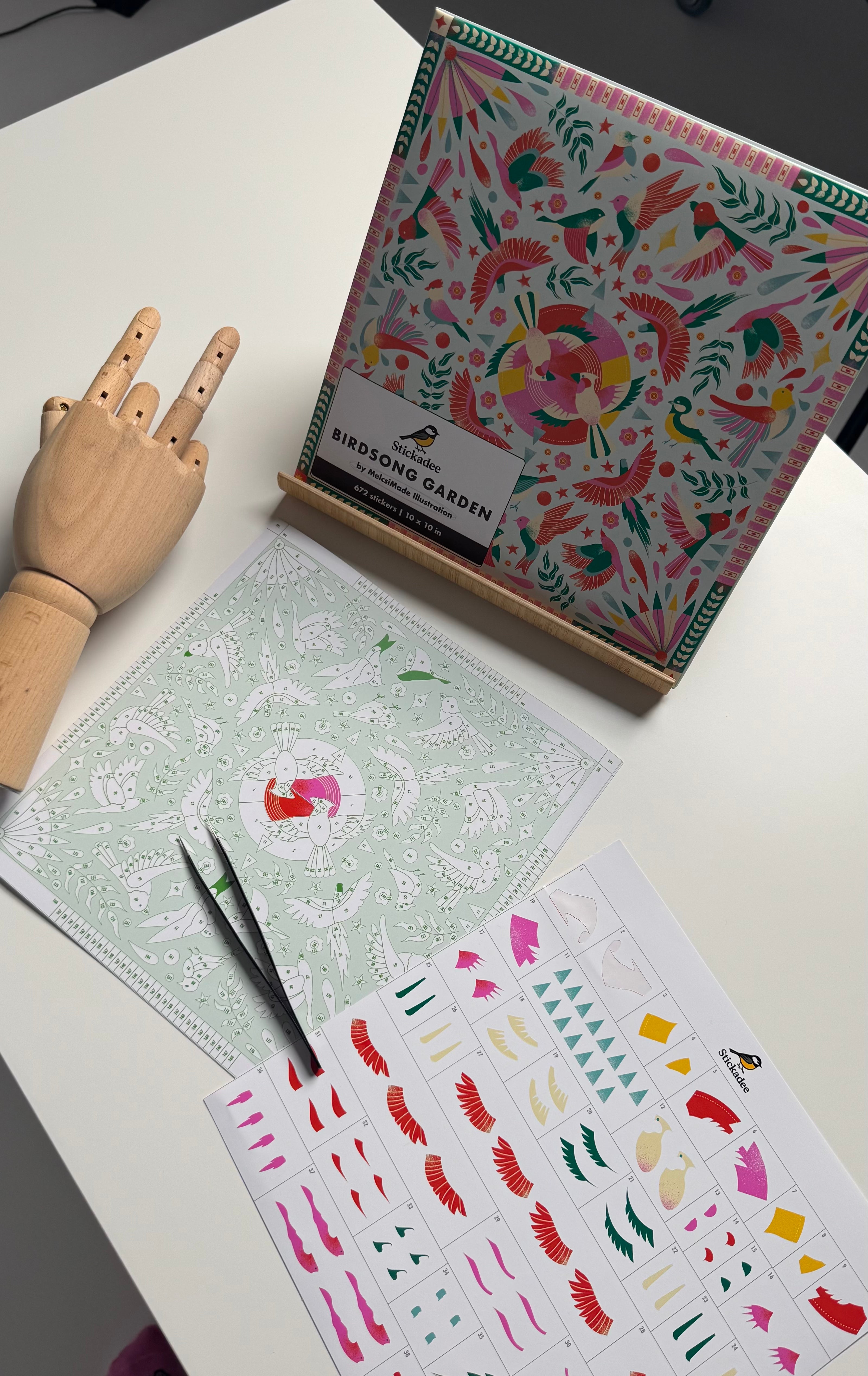 Colorful stationery items including a box, cards, and stickers on a white surface.