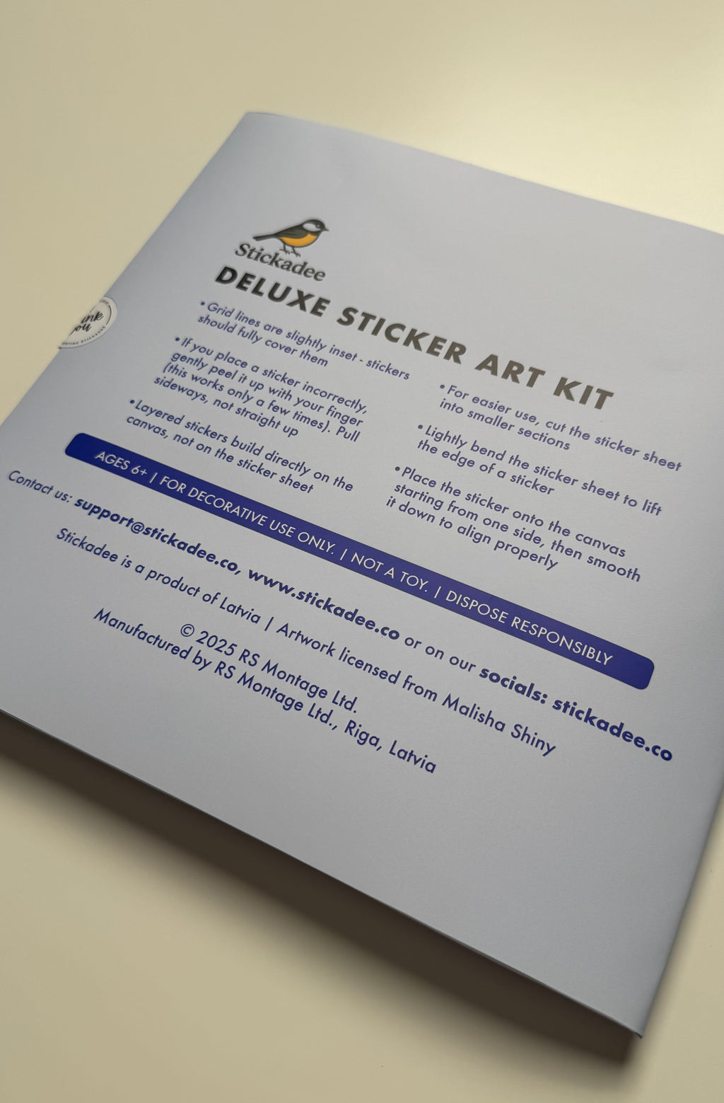 Stickadee Deluxe Sticker Art Kit packaging with text and branding on a beige background