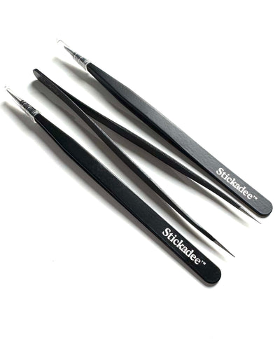 Set of black tweezers with 'Stickadee' branding on a white background